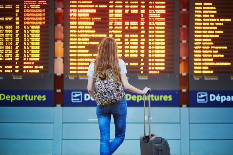 Young Traveler Looking at the Flight Information Board