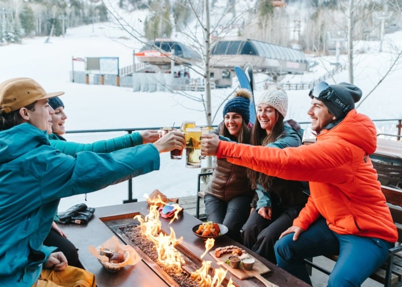 Group of clinking beer glasses at Handle Bar at Four Seasons Resort & Residences Jackson Hole