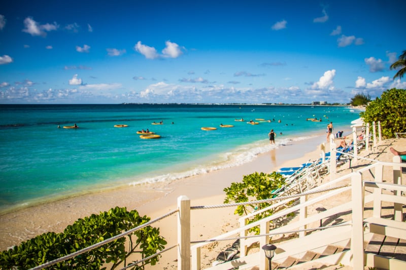 Cayman Islands beach resort with white sand and blue-green water.