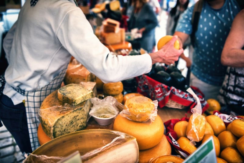 Selection of Dutch cheese at farmers traditional market.  Food background