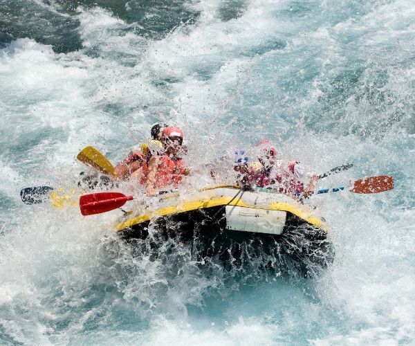 Group of people whitewater rafting