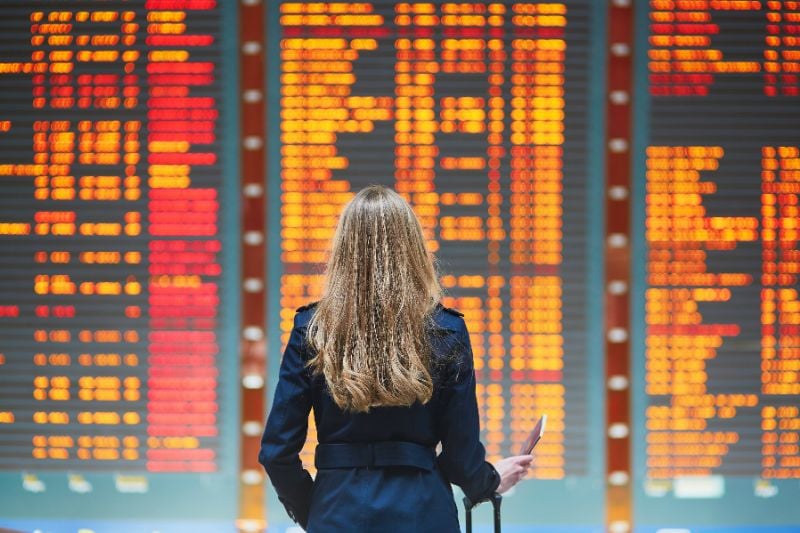 Traveler looks at the Flight Information Board