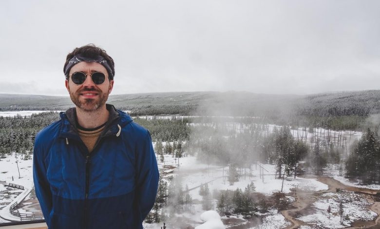 A traveler enjoys snowy Artist Paintpots at Yellowstone National Park.