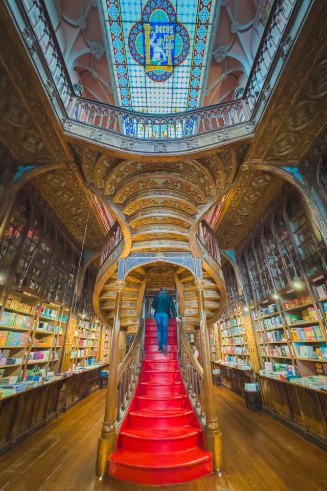 stained glass skylight and majestic staircase at Livraria Lello