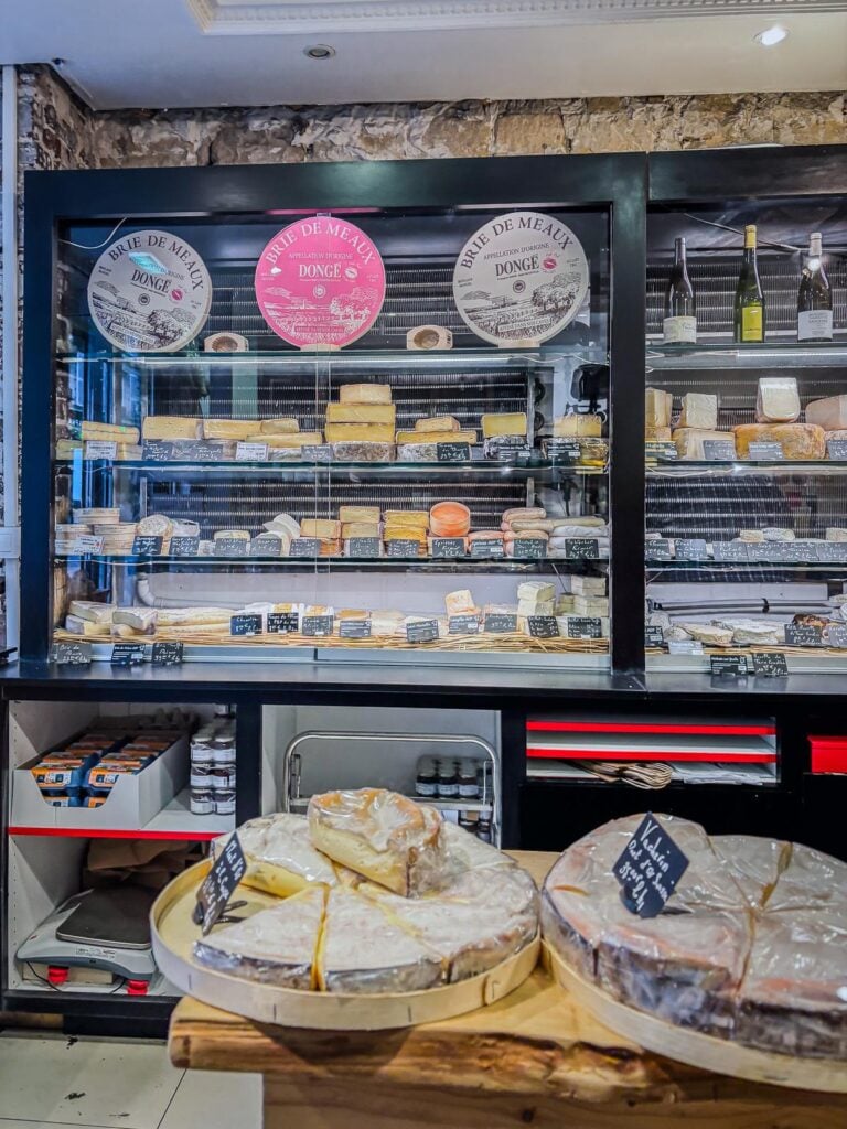 Artisanal cheese ripening process at Paroles de Fromagers in Paris, France, showcasing different stages of cheese ripeness, French cheeses, wine pairings and traditional ripening techniques.