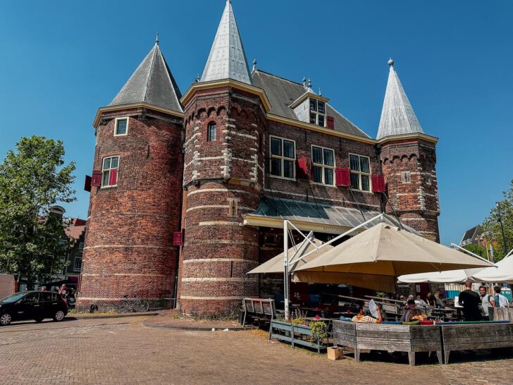 Historic building De Waag in Amsterdam, with medieval architecture and a vibrant market life